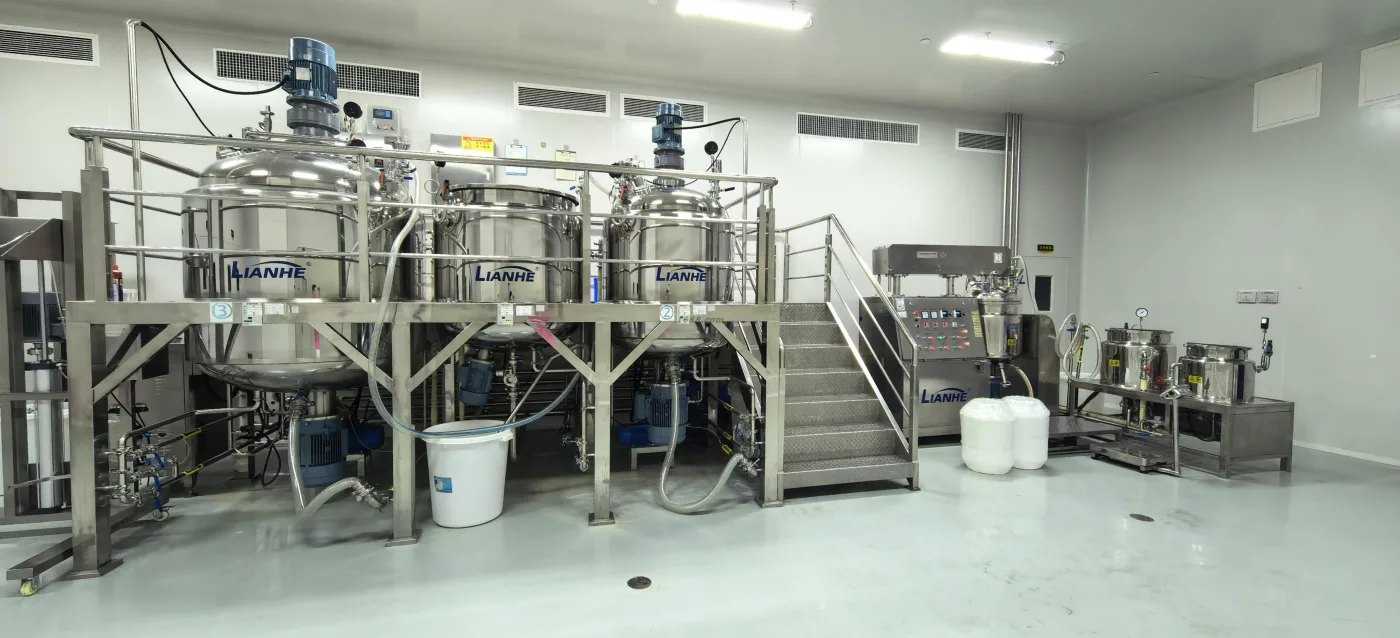 Large stainless-steel processing tanks in a controlled workshop